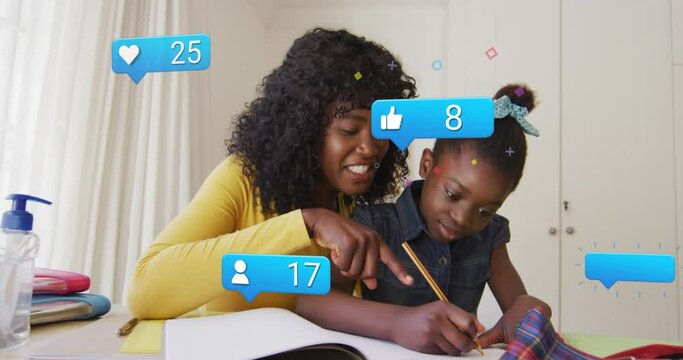 Animation of social media icons over african american mother and daughter doing homework