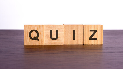 wooden cubes with text QUIZ on wooden table. financial loss busines concept