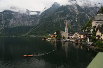 A man peacefully rowing a small boat on a lake, Austria © Foto