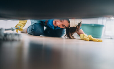Enthusiastic house cleaning lady do various tasks with responsibility. Using mop, broom, laundry...