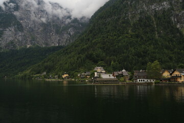 Fototapeta na wymiar Austria's Scenic Village Enveloped by Majestic Mountains and a Sparkling Lake