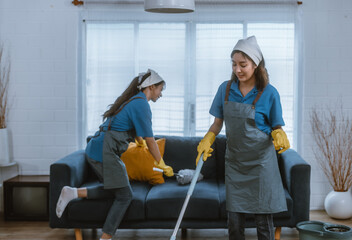 Enthusiastic house cleaning lady do various tasks with responsibility. Using mop, broom, laundry...