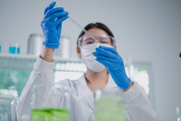 Female scientist is doing an experiment of cosmetic, skincare and treatment laboratory. Fresh...