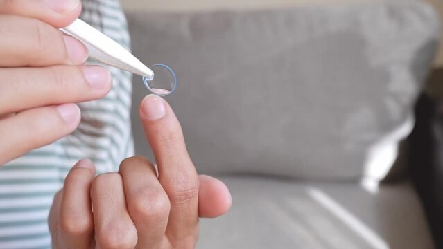 Close up woman takes out contact lenses from the container, correction of the concept of vision in case of myopia
