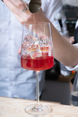 Preparation of alcoholic berry cocktail in the bar