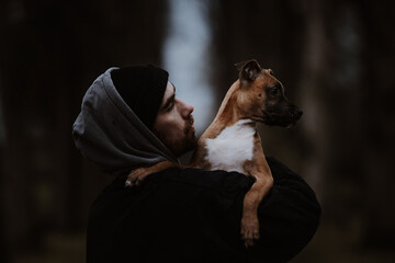 Tattooed Man and dog. Pitbull and street guy.
