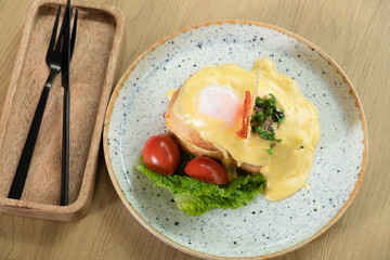 Toast with egg, ham and cheese under bechamel sauce. Delicious breakfast in the restaurant