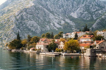 Fototapeta na wymiar Long shot autumn view of the picturesque town of Perast in the Bay of Kotor with beautiful historic buildings and boats, Montenegro