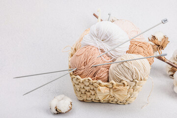 A set of pastel clew of thread for knitting in a basket. Handmade, hobby, crochet concept