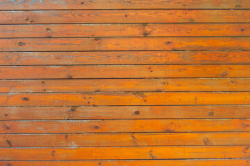 Naklejka premium The texture of a brown wooden floor, worn in places.