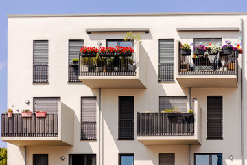Balcony Facade of Modern Apartment Building. Garden Flowers on Balconies in Europe. 