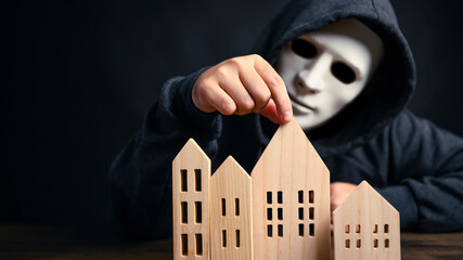 Burglar thief considering to choosing for stealing uninhabited houses in city in black dark...