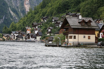 Fototapeta premium A lakeside town with colorful buildings and boats on the water, Austria