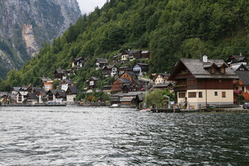 Fototapeta na wymiar A lakeside town with colorful buildings and boats on the water, Austria