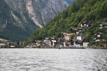 Fototapeta na wymiar A lakeside town with colorful buildings and boats on the water, Austria