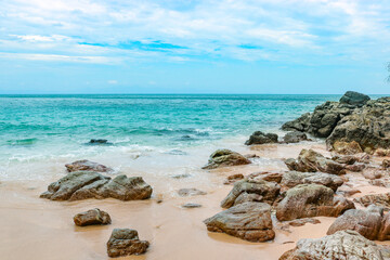 Tropical sandy rocky beach on a desert island with clear clear blue water. Romance and adventure.