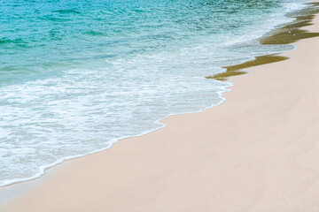 Fototapeta na wymiar Soft beautiful ocean wave on sandy beach. Background. Copy space.