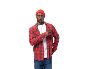 handsome smart dark-skinned man in casual plaid shirt shows his hand to the proposal on a white background with copy space