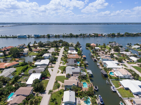 Aerial view of a Florida barrier island community with canals along the intracoastal waterway.