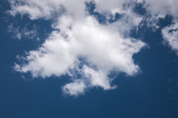 Close-up of a white cloud against a dark blue sky. cloud background