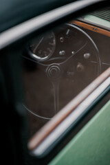 Oldtimer car dashboard. Retro car interior. Old steering wheel detail.