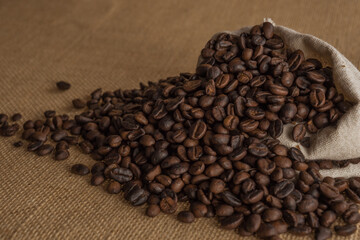 Roasted coffee beans on hemp background.