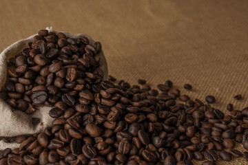 Roasted coffee beans on hemp background.