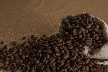 Roasted coffee beans on hemp background.