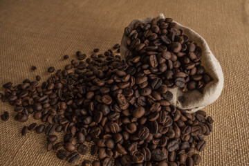 Roasted coffee beans on hemp background.