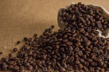 Roasted coffee beans on hemp background.
