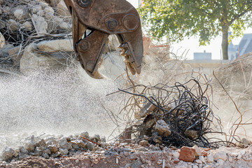 Crusher demolishing concrete and steel on a demolition project