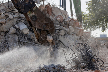Crusher demolishing concrete on a demolition project