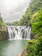Fototapeta premium Shifen waterfall, landmark natural viewpoint near Taipei, Taiwan, in summer season.