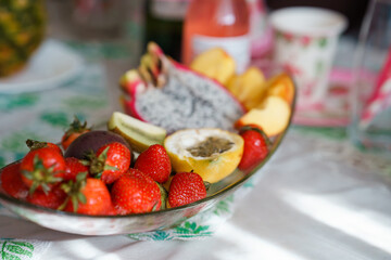 Pitahaya, passion fruit, strawberries and other fruits are on the plate. Exotic fruits, the concept of proper healthy nutrition