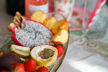 Pitahaya, passion fruit, strawberries and other fruits are on the plate. Exotic fruits, the concept of proper healthy nutrition