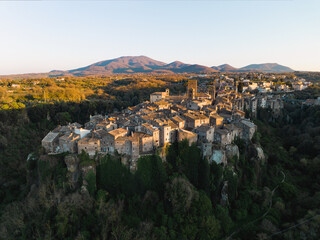 Fototapeta na wymiar View from above, stunning aerial view of the village of Vitorchiano at sunset. Vitorchiano is a medieval Italian village in Viterbo Province, Lazio, Italy..