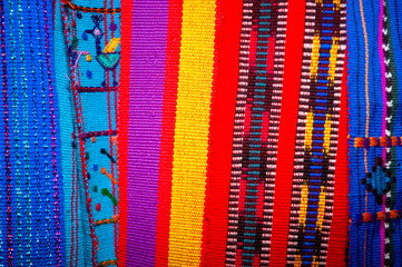 Colorful textile for sale in public space in Guatemala City, work done by indigenous hands of millenary Mayan culture, handicraft work economy in Latin America. - 620626429