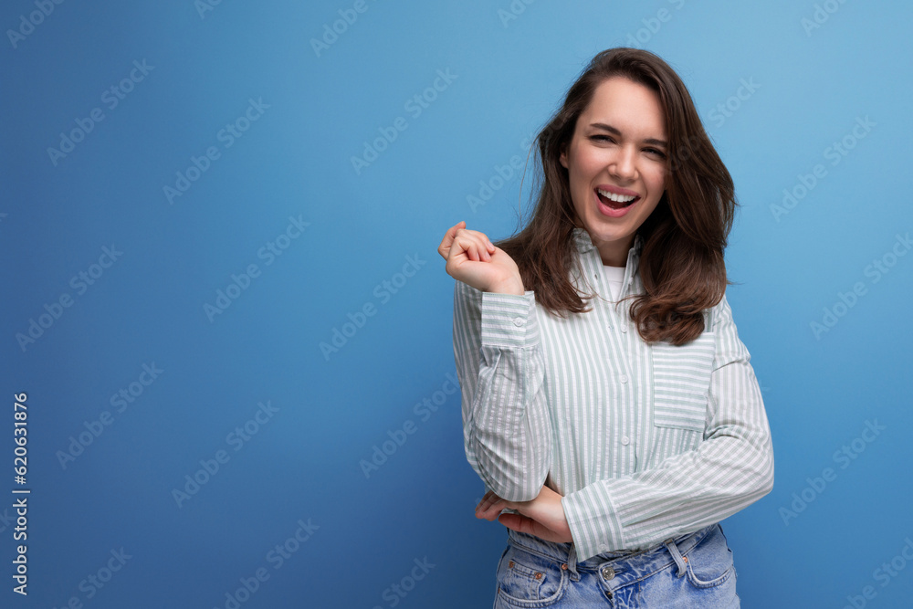 Canvas Prints young brunette woman in shirt with healthy silk hair on studio background