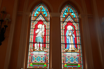 Stained glass depicting a picture in the church.