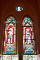 Stained glass depicting a picture in the church.