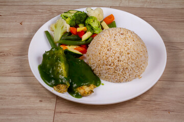 Keto Grilled Fish & Veggies in white plate on wooden background