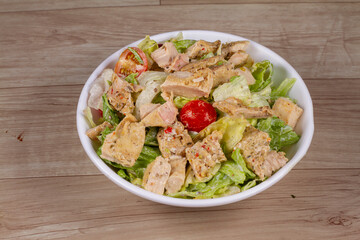 Sriracha Chicken Salad in white bowl on wooden background