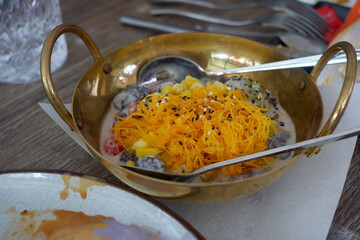 Golden threads in a brass cup.