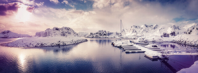 Amazing winter nature scenery. Colorful sky over the sea, snowy mountains and north fjord snow covered mountains. Norway. Lofoten islands during sunset, Stunning Norway landscape.