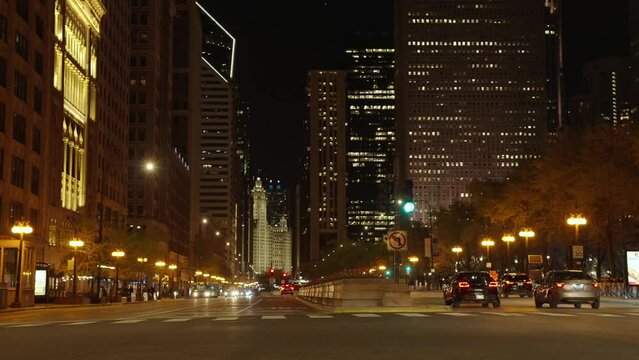 Chicago, USA - April 30, 2023: destination night cityscape of chicago city with road and skyscraper, slow motion