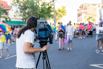television camera operator filming Pride Day demonstration - obrazy, fototapety, plakaty