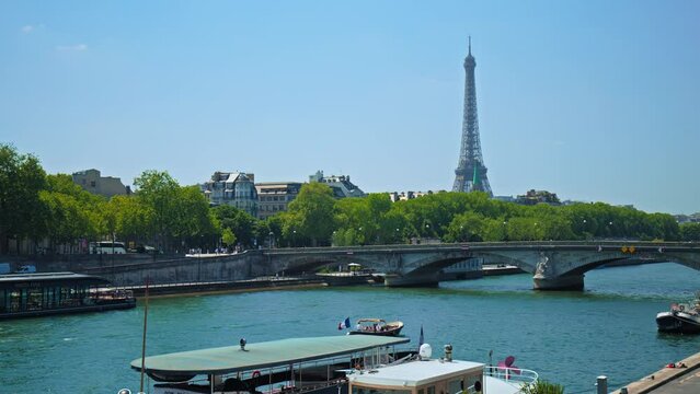 Cruise boat on the River Seine with Eiffel Tower view in Paris, France. Amazing view of the symbolic landmark of Paris from the Pont Alexandre III bridge.