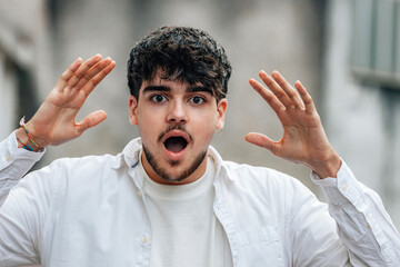 boy in the street with an expression of surprise or astonishment