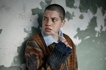 Portrait of homeless hipster teenager woman chewing gum