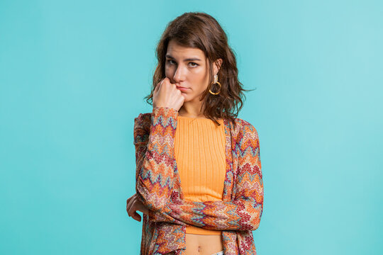 Young Caucasian woman tired bored indifferent expression, exhausted of tedious story, not interested in communication talk, displeasure, uninteresting. Girl isolated on blue studio background indoors